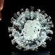British artist Luke Jerram looking at his glass sculpture of the SARS-CoV-2 virus, titled “coronavirus COVID-19,” in a photo taken on March 17, 2020.